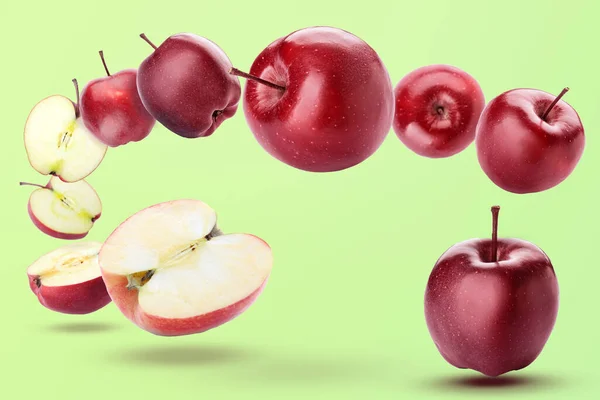 Ripe Red Flying Apples Halves Green Background — Foto de Stock