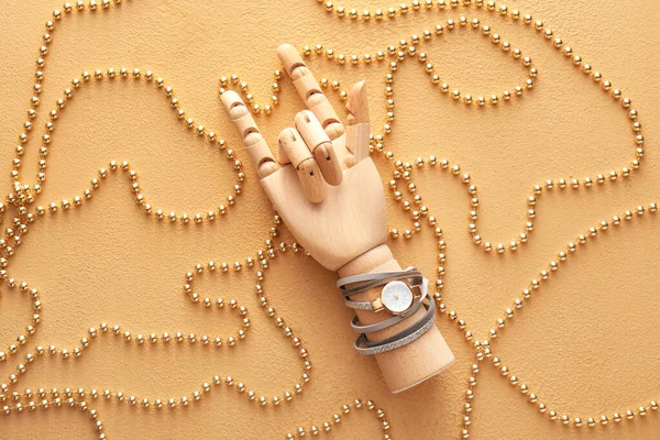 Wooden Hand Wristwatch Beads Showing Love You Gesture Beige Background — Stock fotografie
