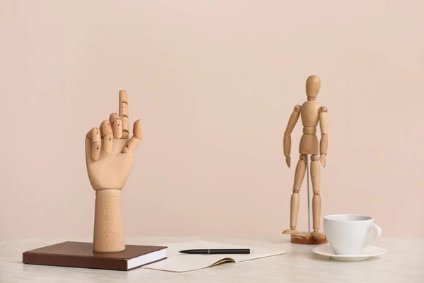 Wooden Hand Notebooks Mannequin Cup Coffee Table Beige Background — Fotografia de Stock