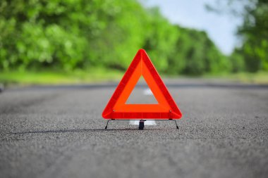 Emergency stop sign as symbol of car accident on road