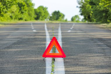 Emergency stop sign as symbol of car accident on road