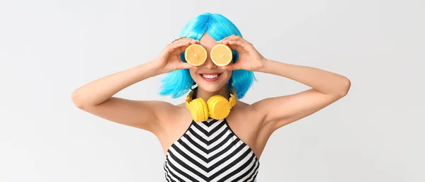Beautiful Young Woman Blue Wig Lemon Headphones Light Background — Stock Photo, Image