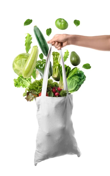 Female Hand Holding Shopping Bag Flying Green Vegetables White Background — Stockfoto