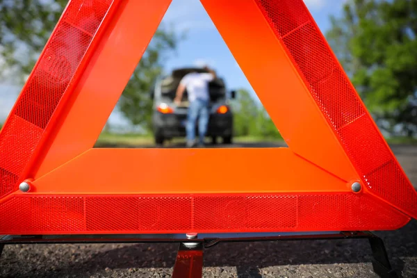 Man Broken Car Visible Red Emergency Stop Sign Closeup — Zdjęcie stockowe