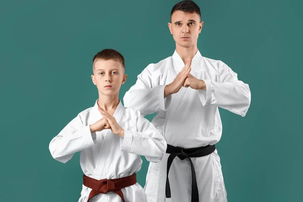 Boy Practicing Karate Instructor Green Background — Stockfoto