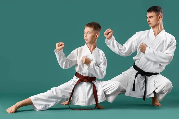 Boy Practicing Karate Instructor Green Background — Stockfoto