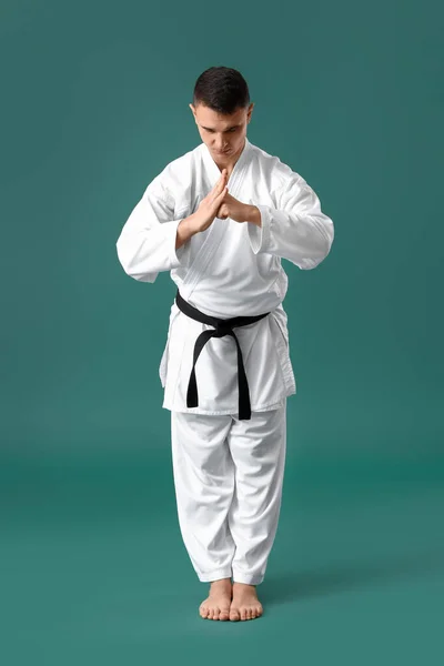 Man Performing Ritual Bow Practicing Karate Green Background — Foto de Stock