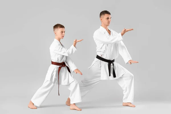 Boy Practicing Karate Instructor Light Background — Stockfoto