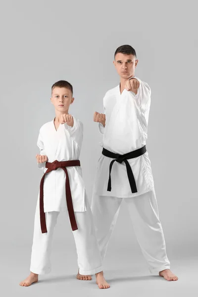 Boy Practicing Karate Instructor Light Background — Stockfoto