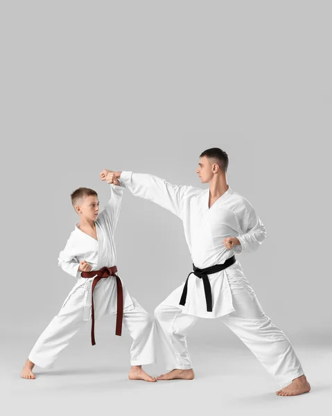 Boy Practicing Karate Instructor Light Background — Stockfoto