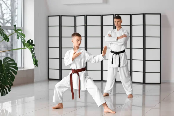 Boy Practicing Karate Watchful Eye Instructor Dojo — стоковое фото