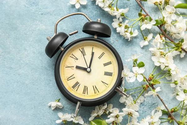 Blooming Spring Branches Alarm Clock Light Blue Background Top View — Stock Fotó