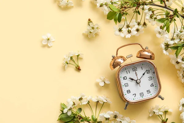 Blooming Spring Branches Alarm Clock Light Color Background Top View — Stockfoto