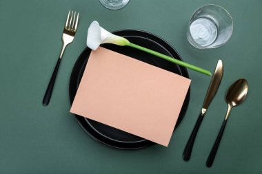 Boş kartıyla güzel masa ayarları ve renk arkaplanında zambak