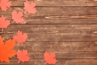 Paper maple leaves on wooden background. Happy Canada Day