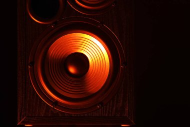 Modern loudspeaker on black background, closeup