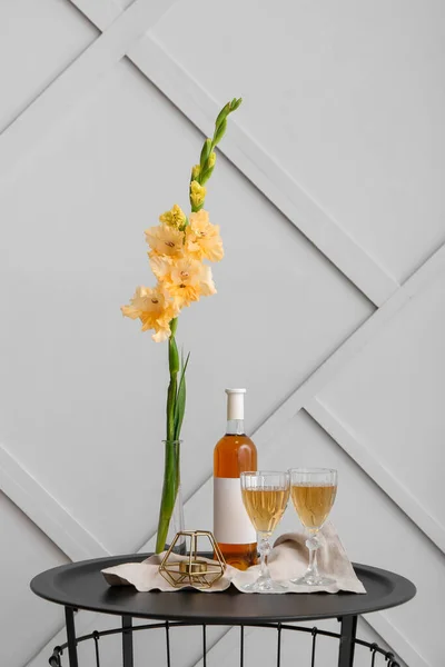 Beautiful Gladiolus Flowers Glasses Bottle Wine Table Light Wall — Stock Photo, Image