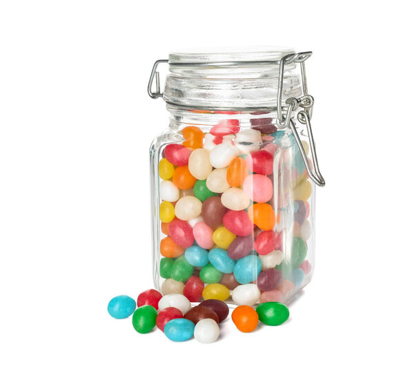 Glass jar with multicolored jelly beans on white background