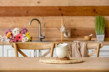 Table with cups in modern kitchen