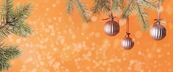 Beautiful Christmas Balls Hanging Coniferous Branch Orange Background — 스톡 사진