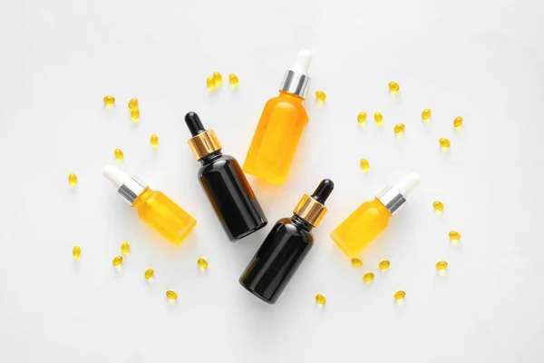 Bottles Essential Oil Vitamin Capsules White Background — Zdjęcie stockowe