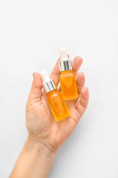 Woman Holding Bottles Essential Oil White Background Closeup —  Fotos de Stock