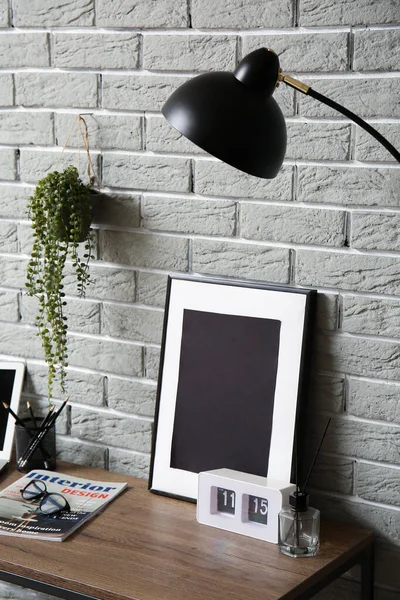 Eyeglasses Magazine Alarm Clock Picture Frame Wooden Table Grey Brick — Stock Photo, Image