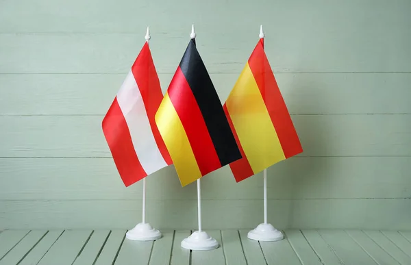 Flaggor Österrike Tyskland Och Spanien Bordet Mot Färg Trä Bakgrund — Stockfoto
