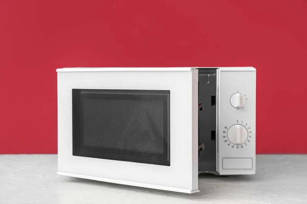 Modern Microwave Oven Opened Door Table Color Background — Stock Photo, Image