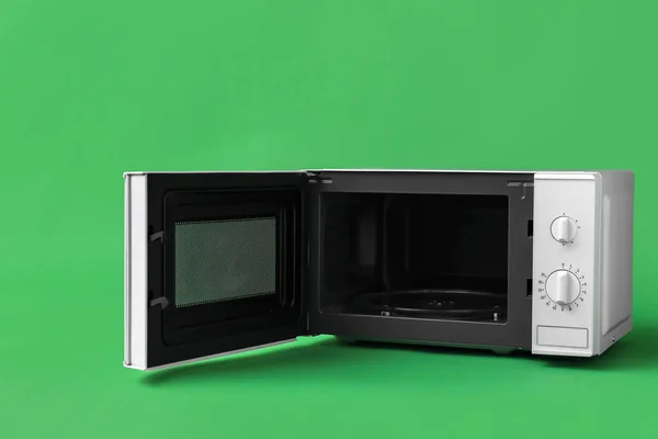 White Microwave Oven Opened Door Green Background — Stock Photo, Image