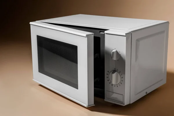 White Microwave Oven Opened Door Beige Background — Stock Photo, Image