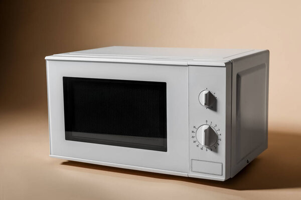 White microwave oven on beige background