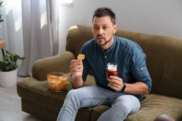 Handsome Man Drinking Beer Eating Chips While Watching Sports Home — Fotografia de Stock