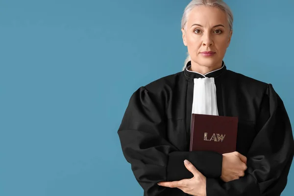 Mature Female Judge Robe Law Book Blue Background — Stok fotoğraf