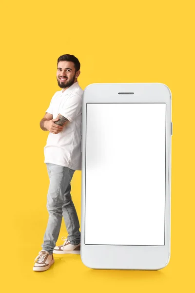 Cool Tattooed Young Man Big Smartphone Yellow Background — Stock Photo, Image