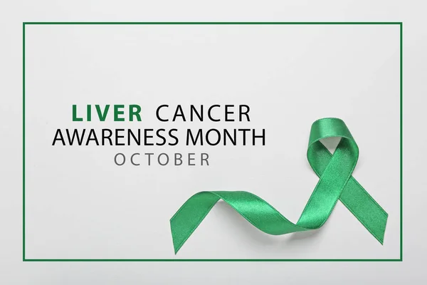 Green ribbon and text LIVER CANCER AWARENESS MONTH - OCTOBER on light background
