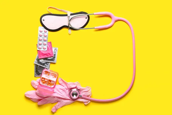 Frame Made Pills Condoms Stethoscope Gloves Blindfold Yellow Background — Fotografia de Stock