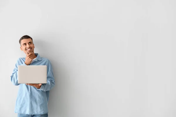 Thoughtful Young Man Using Laptop Light Background — Stock Photo, Image