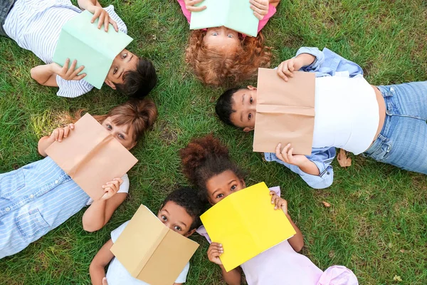 Crianças Pequenas Com Livros Deitados Grama Verde Parque — Fotografia de Stock