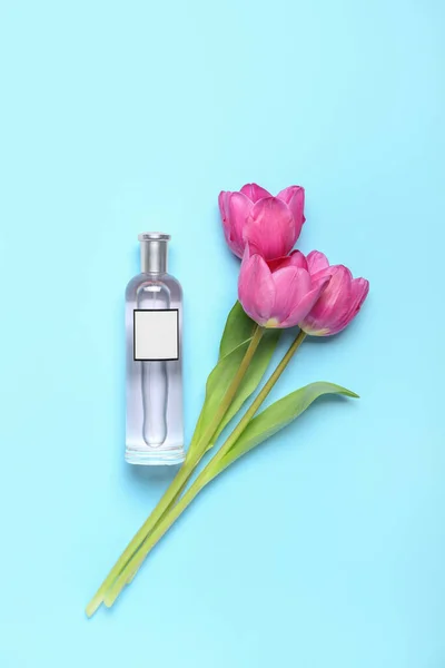 Beautiful Pink Tulips Perfume Bottle Blue Background — Zdjęcie stockowe