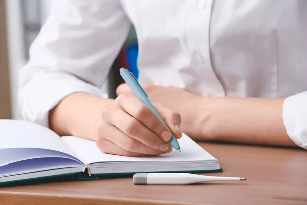 Female Doctor Writing Notebook Table Clinic Closeup — Stock Photo, Image