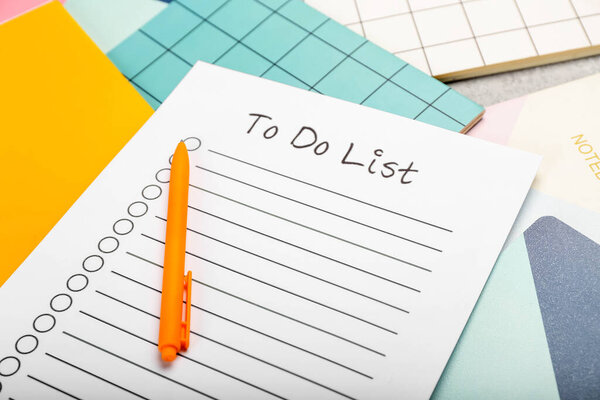 Blank to do list, pen and notebooks, closeup