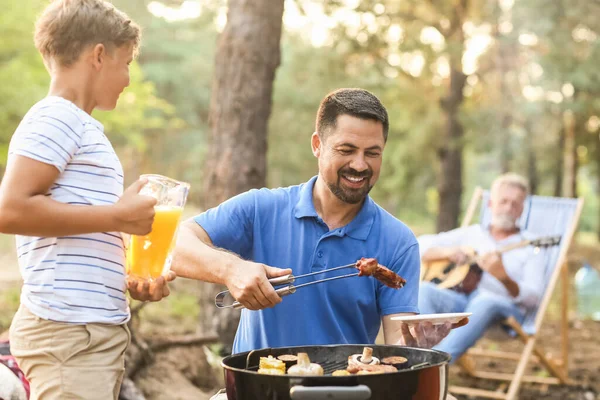 Handsome Man Putting Grilled Meat Plate Barbecue Party — Stockfoto