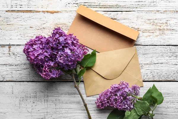 Purple Lilac Flowers Envelopes White Wooden Background — Stok fotoğraf