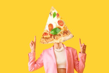 Stylish young woman with piece of tasty pizza instead of her head showing something on yellow background