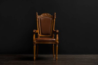 Beautiful vintage chair near black wall