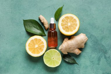 Renkli arka planda gerekli yağ, zencefil ve narenciye içeren kompozisyon