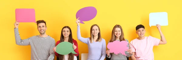 Group Young People Blank Speech Bubbles Yellow Background — Stockfoto