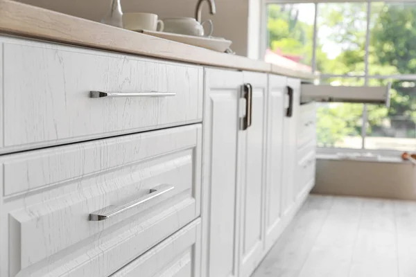 White kitchen drawers in modern room, closeup