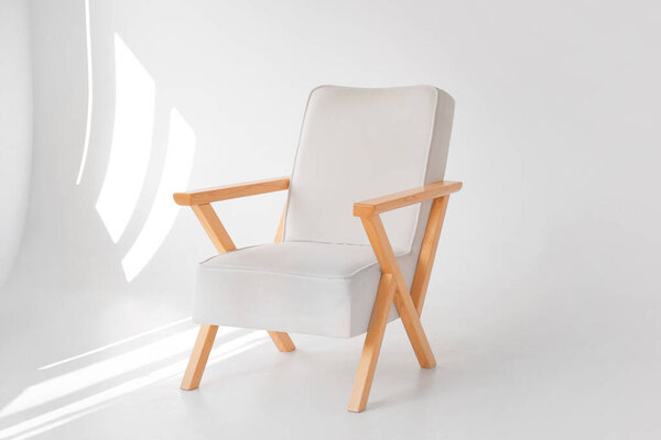 Stylish wooden armchair in modern photo studio